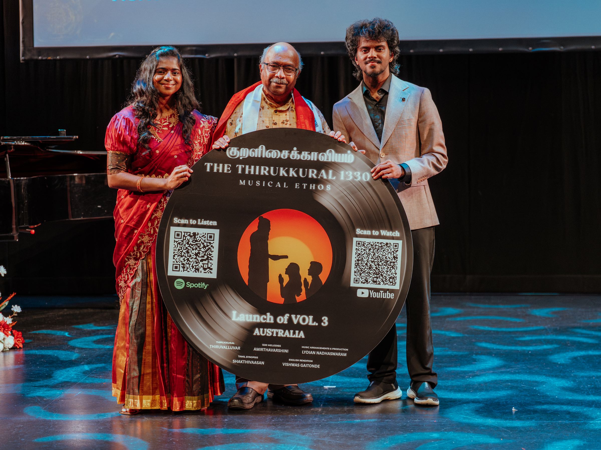Presenters holding the Vol. 3 record artwork