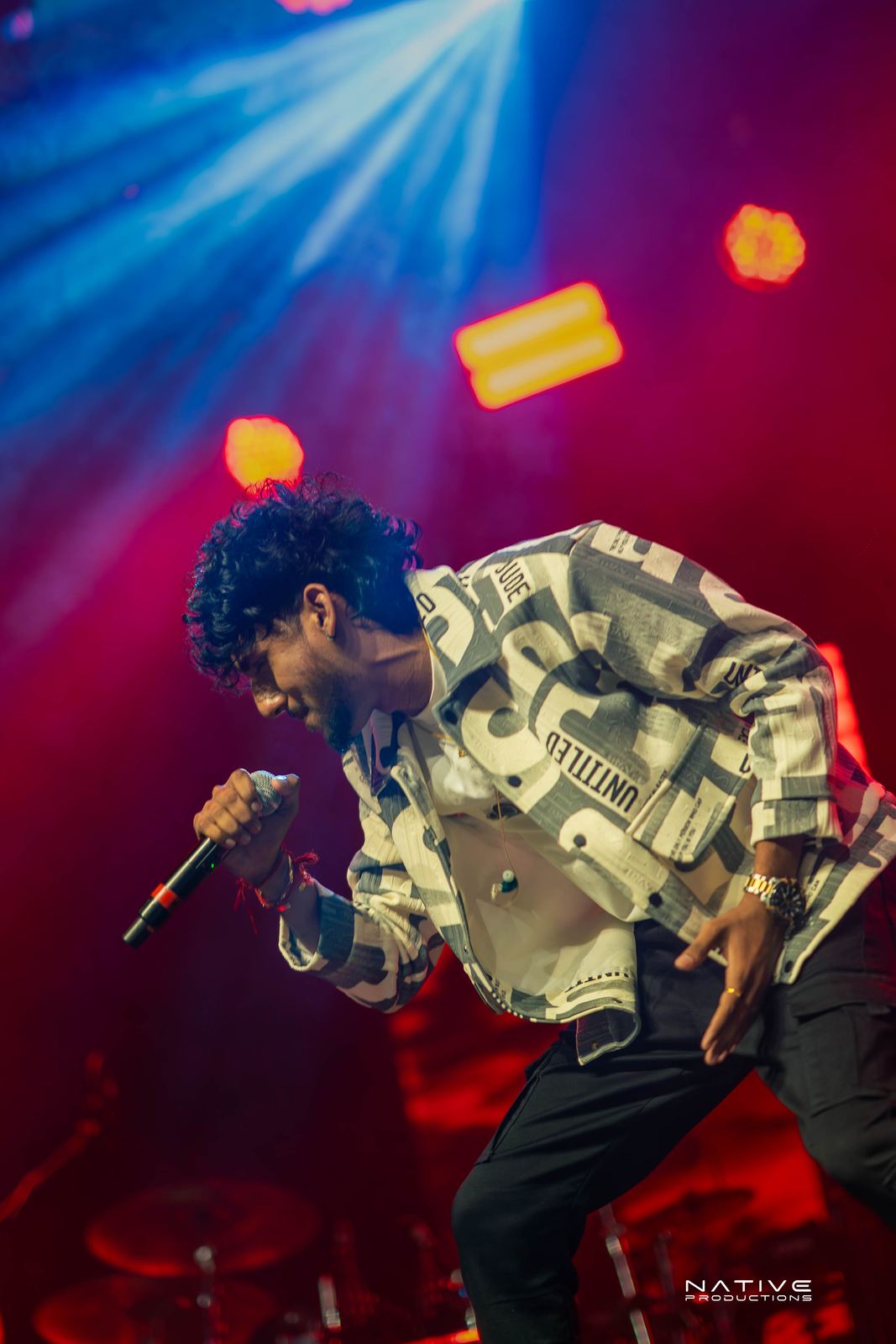 Performer on stage at the Engada Pediyal Tamil rap concert in Melbourne