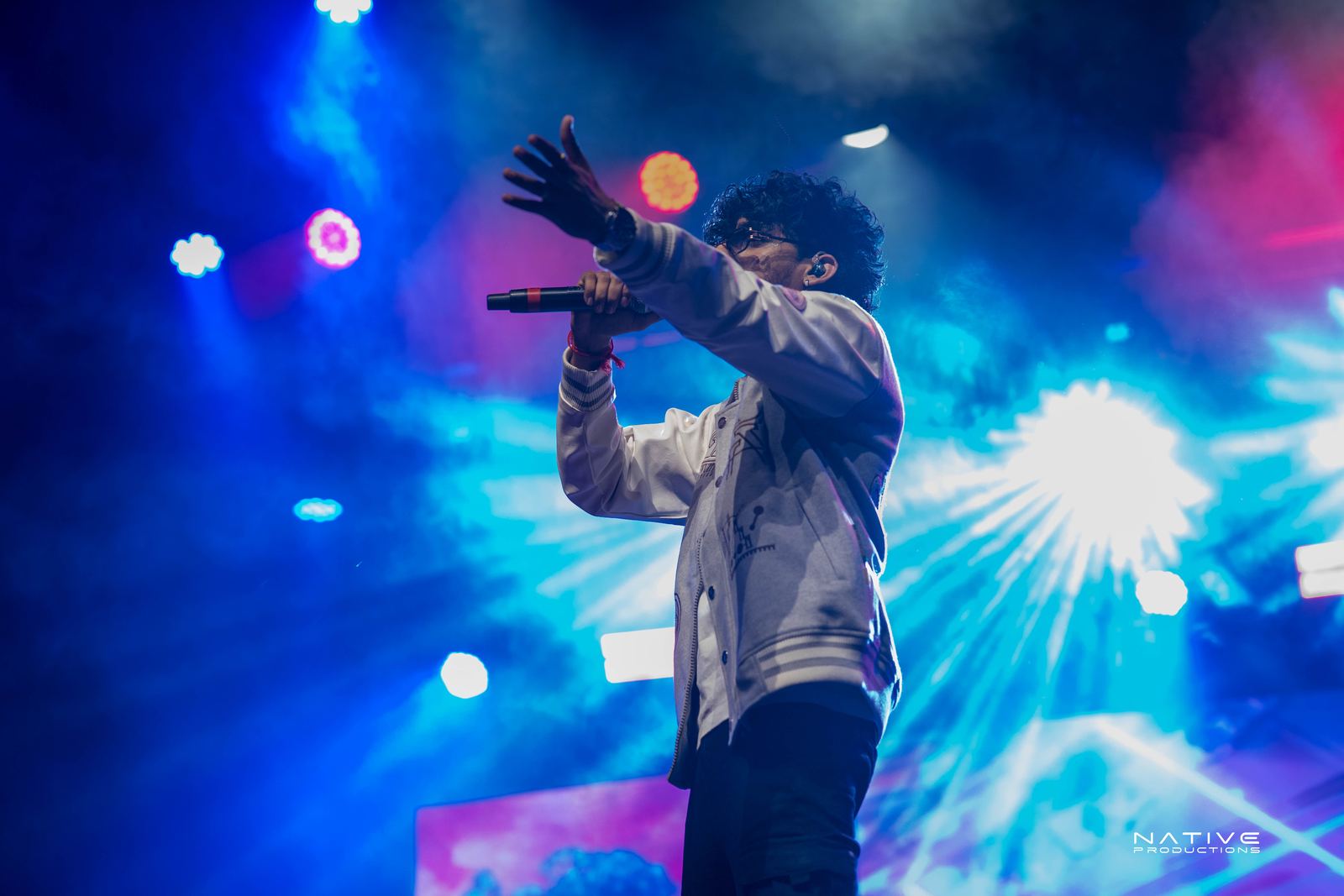 Performer on stage at the Engada Pediyal Tamil rap concert in Melbourne