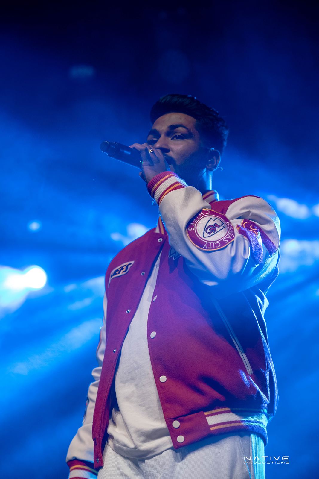 Performer on stage at the Engada Pediyal Tamil rap concert in Melbourne
