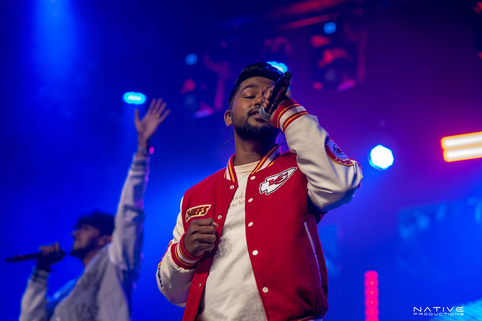 Performer on stage at the Engada Pediyal Tamil rap concert in Melbourne