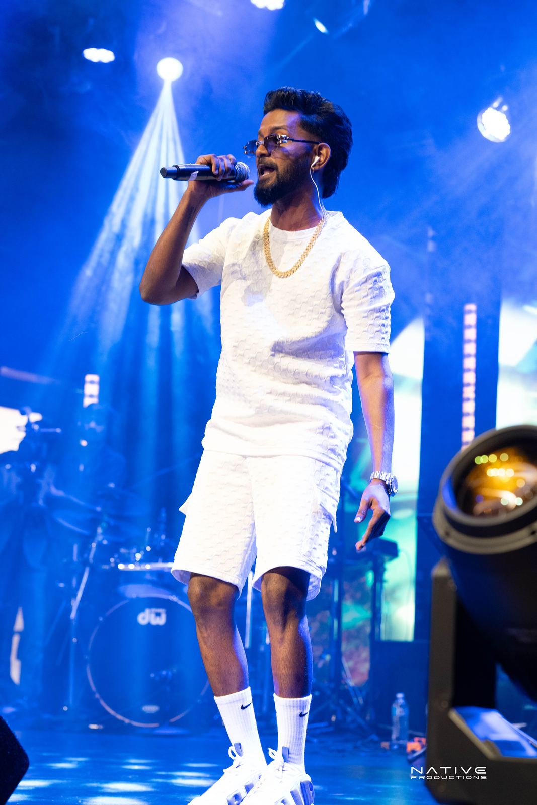 Performer on stage at the Engada Pediyal Tamil rap concert in Melbourne