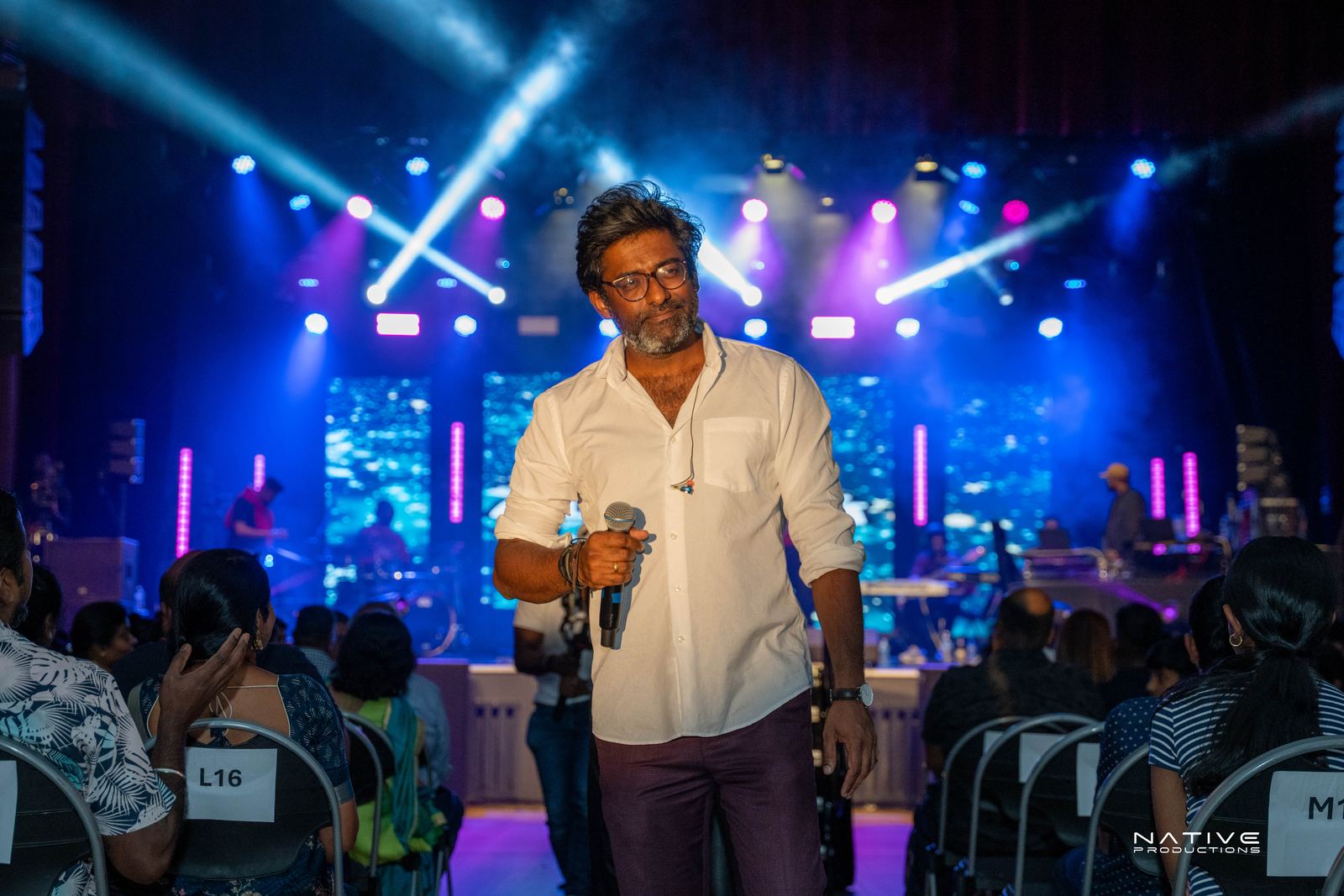Performer on stage at the Engada Pediyal Tamil rap concert in Melbourne