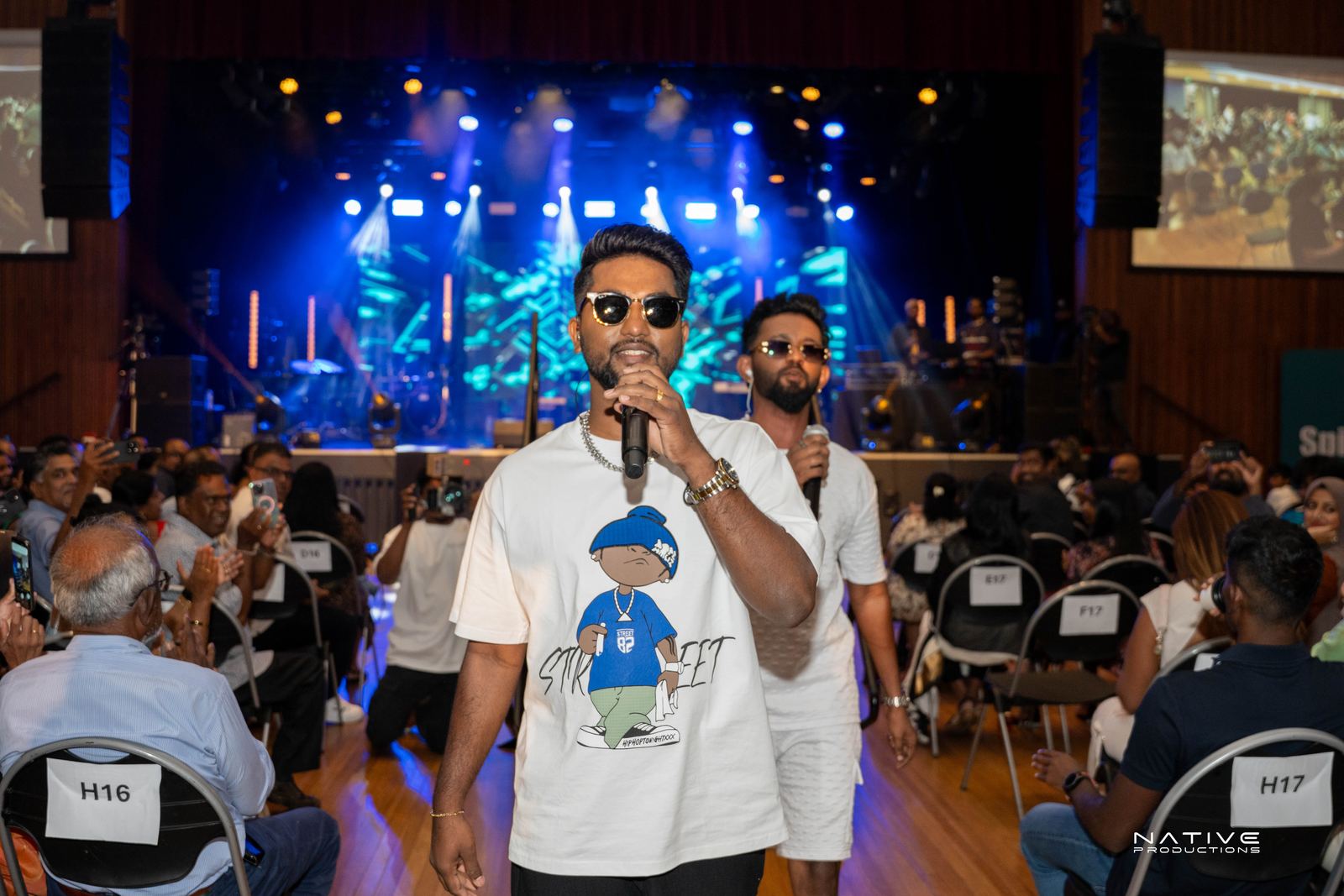 Performer on stage at the Engada Pediyal Tamil rap concert in Melbourne