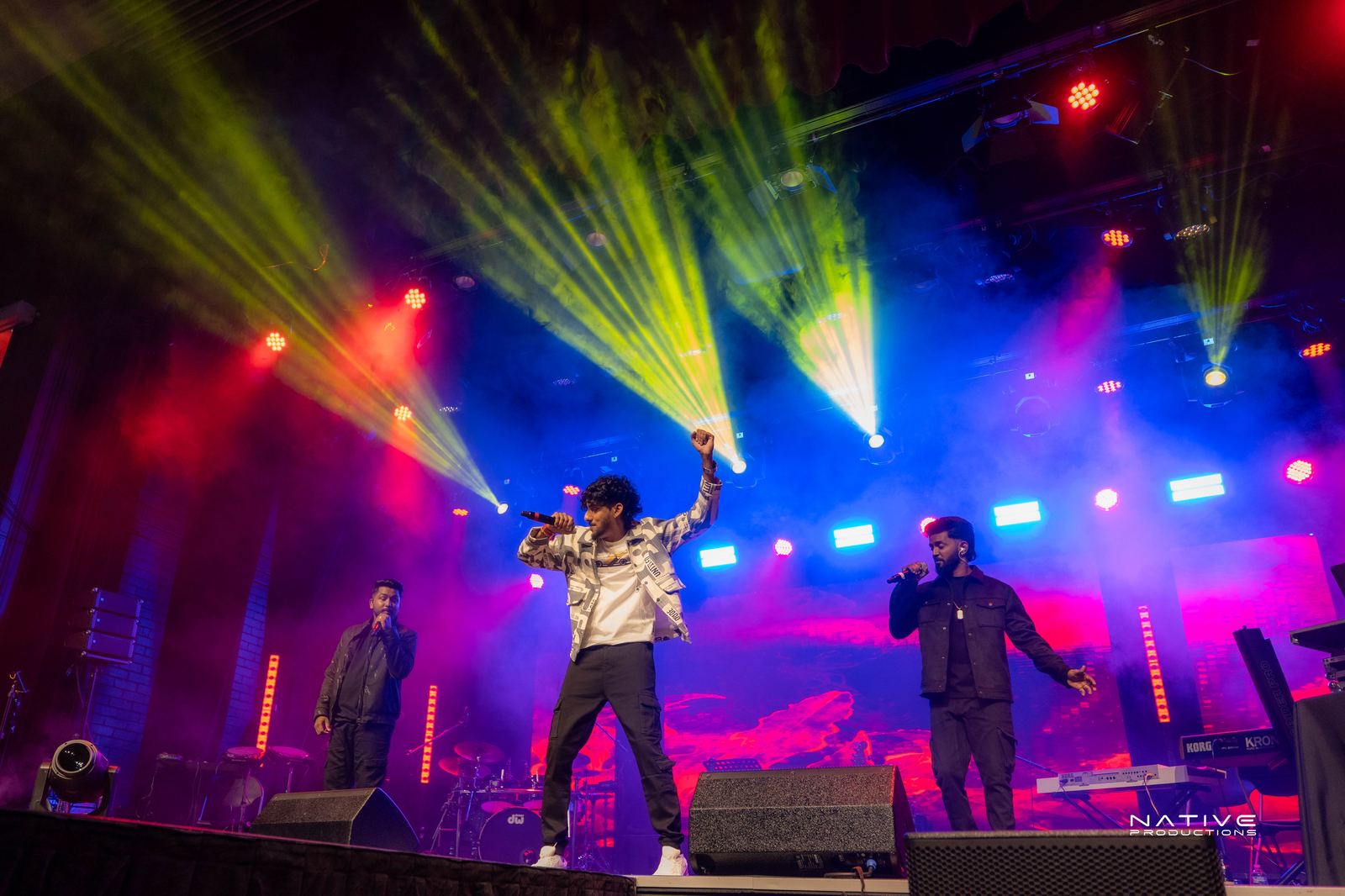 Performer on stage at the Engada Pediyal Tamil rap concert in Melbourne
