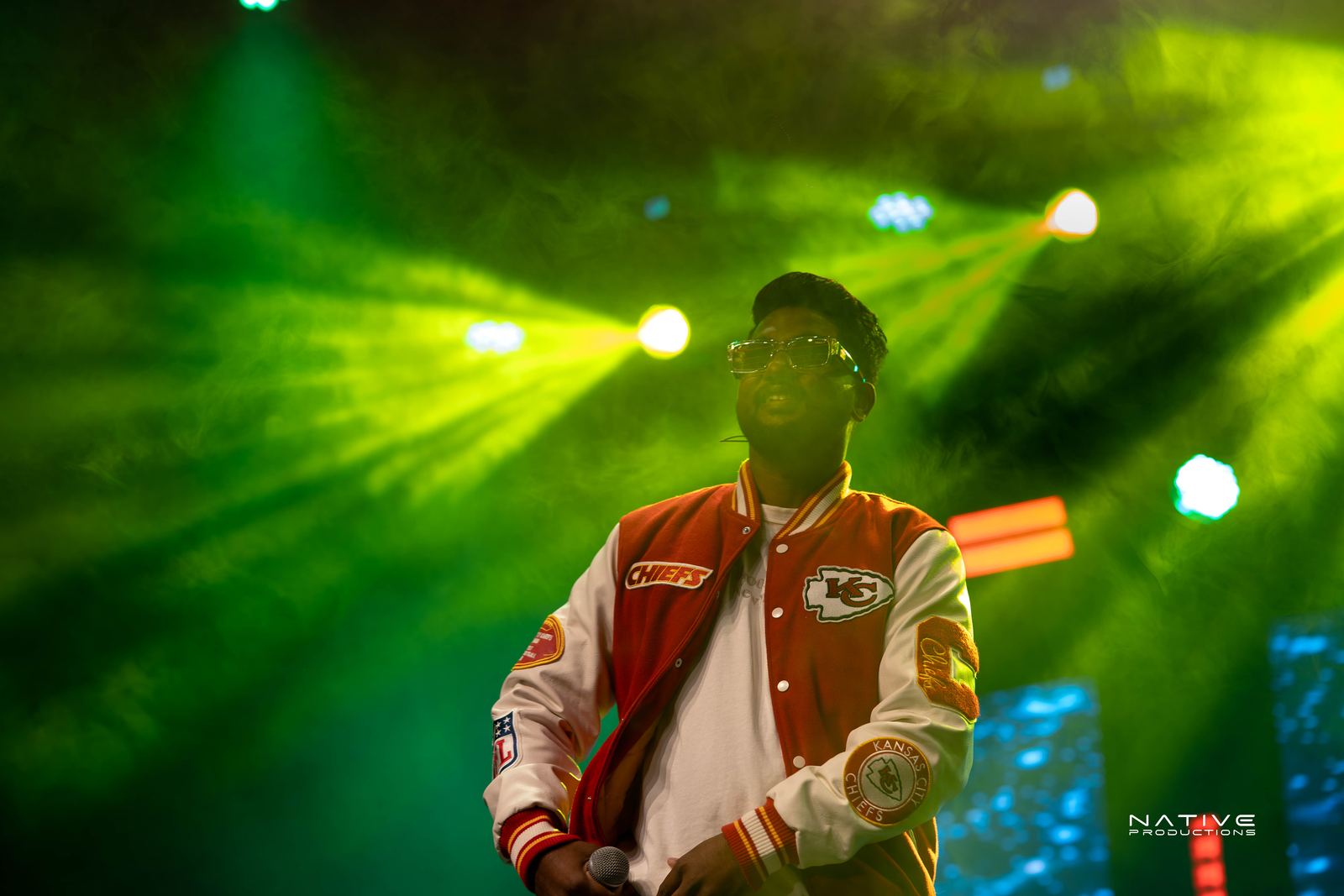 Performer on stage at the Engada Pediyal Tamil rap concert in Melbourne