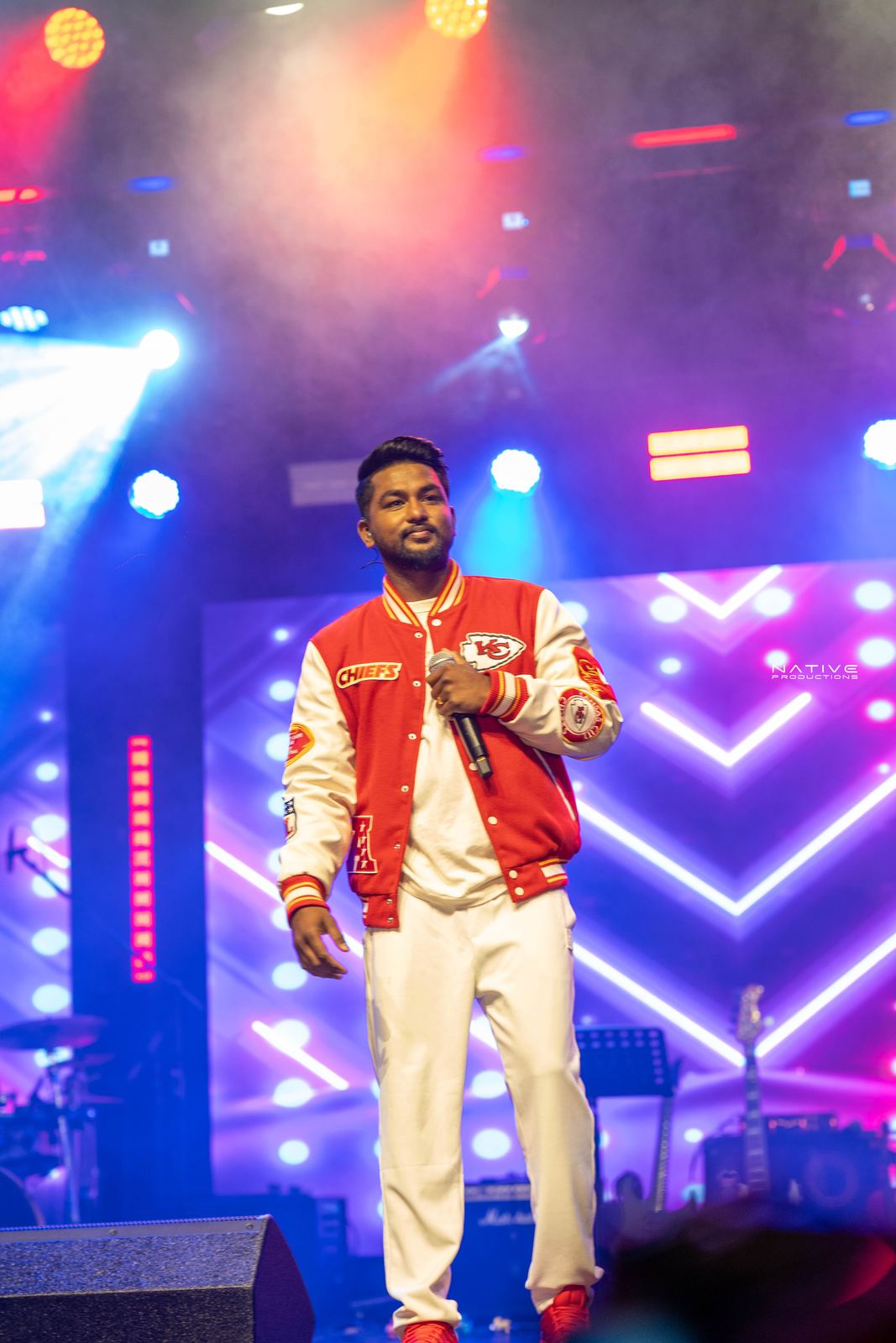 Performer on stage at the Engada Pediyal Tamil rap concert in Melbourne