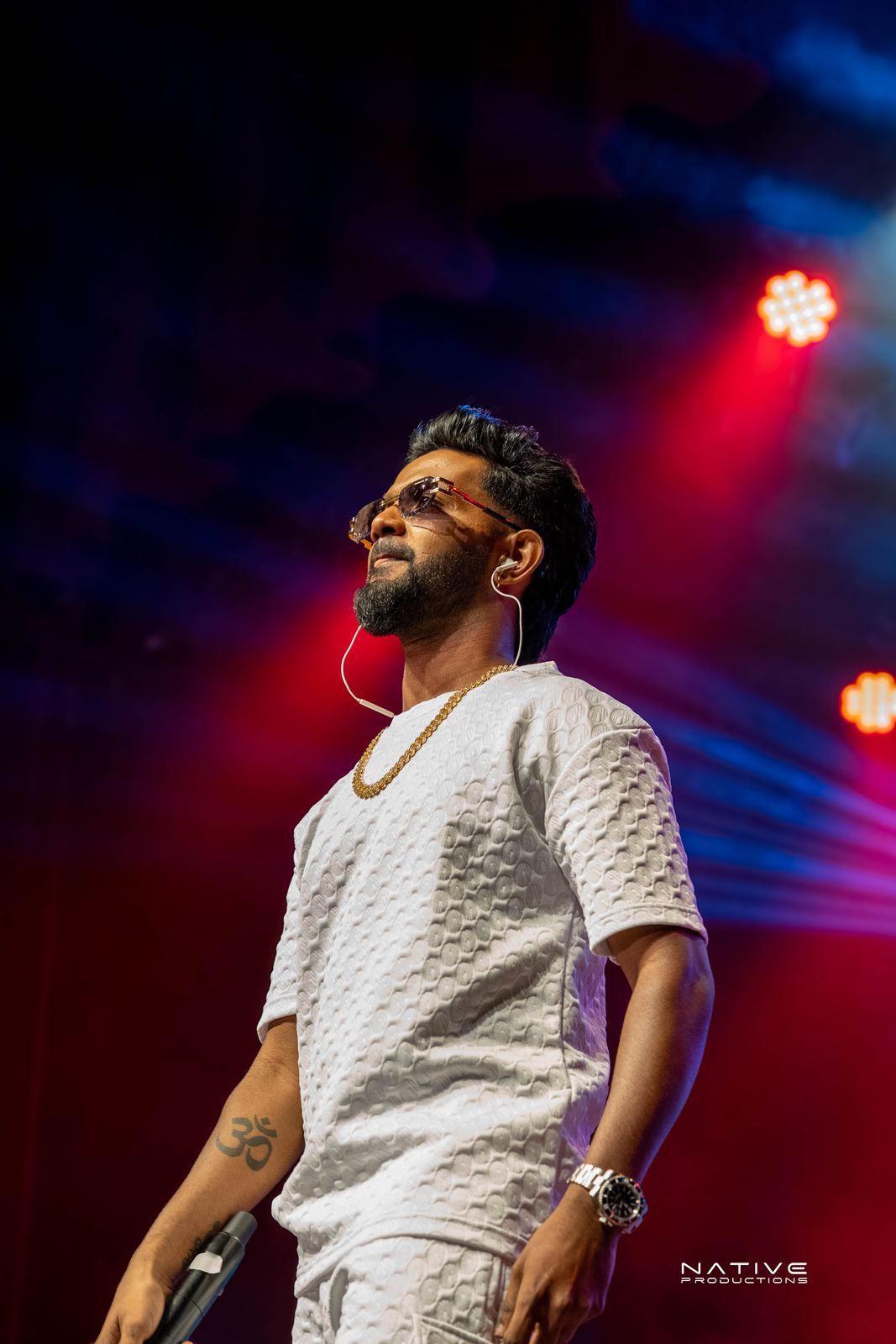 Performer on stage at the Engada Pediyal Tamil rap concert in Melbourne