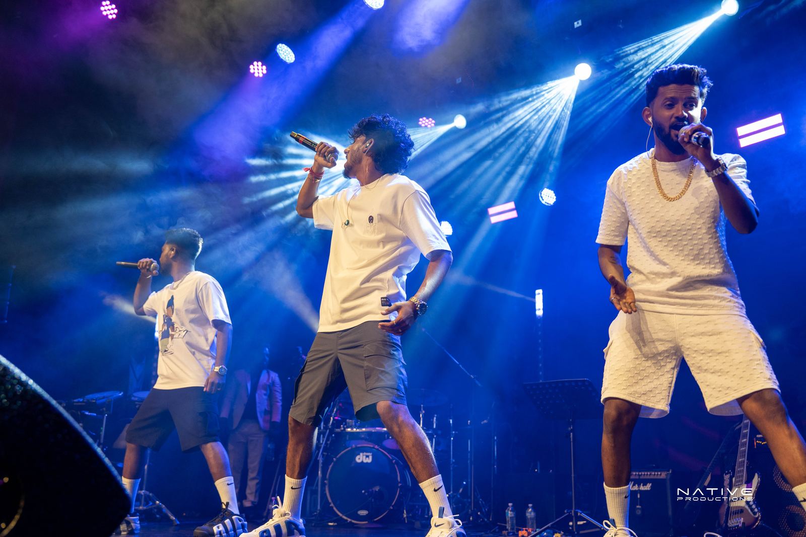 Performer on stage at the Engada Pediyal Tamil rap concert in Melbourne