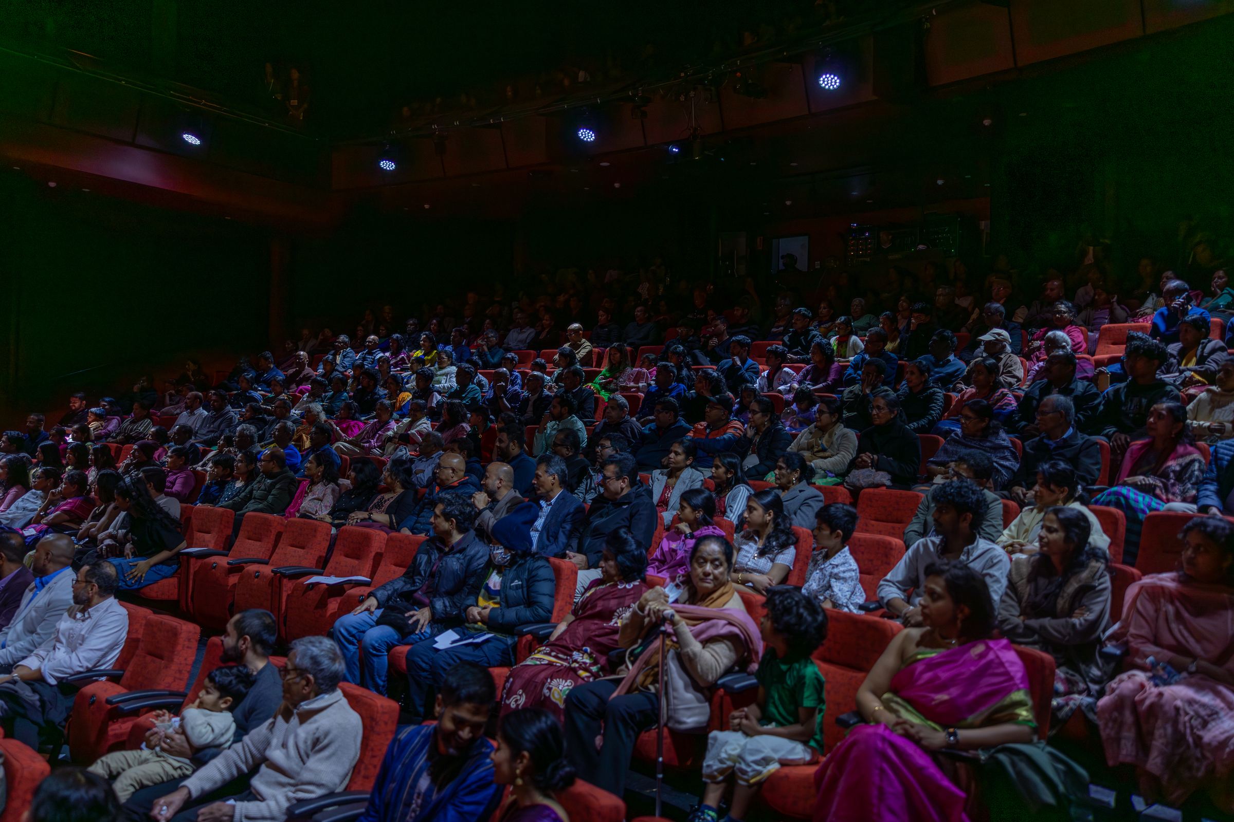 A full theatre audience in the dark