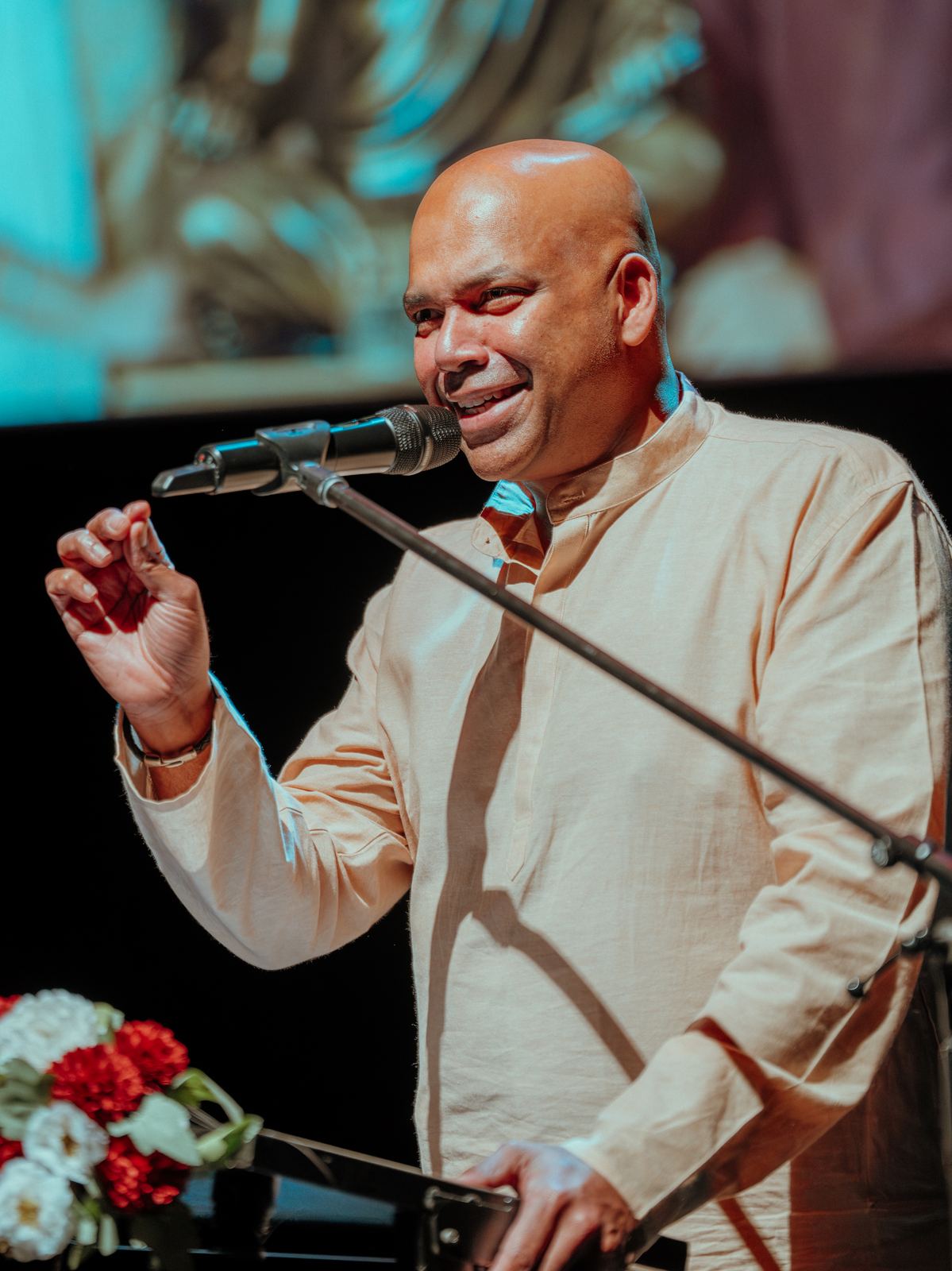 A speaker laughing at the lectern