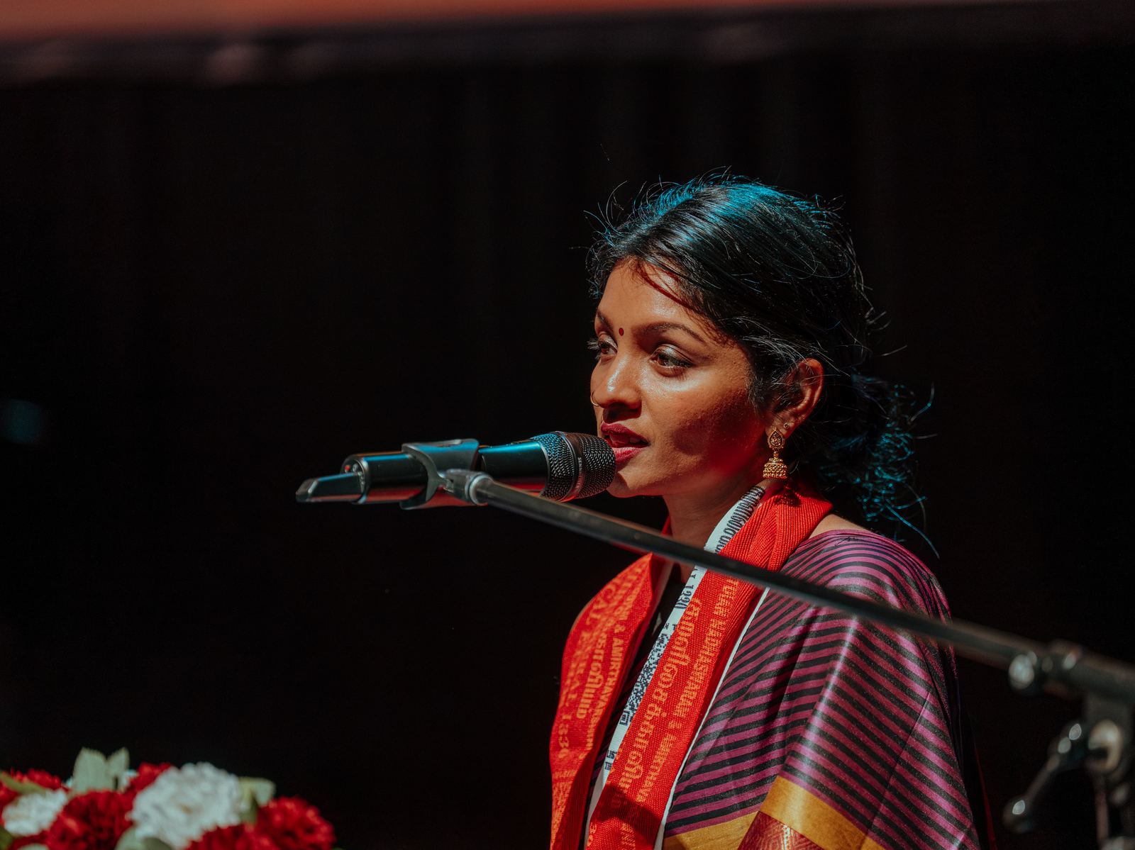 A reader in a silk shawl at the microphone